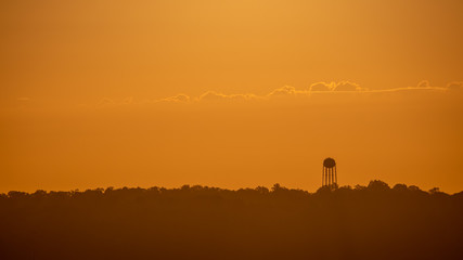 Silhouette of a water tower during sunrise