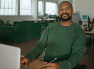 Content African American designer working at his office desk