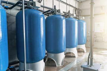 Purified drinking water factory or plant, large iron tanks and water purification filters and...