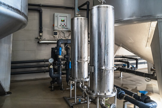 Purified drinking water factory or plant, large iron tanks and water purification filters and automation filtration system