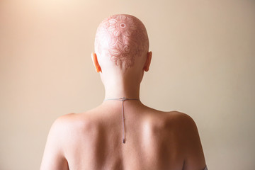 Henna mehndi tattoo on womans bald head