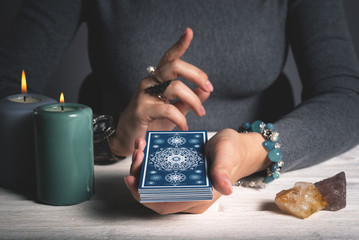 Tarot cards in fortune teller hands concept.