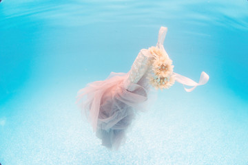 Pretty dress floating in water