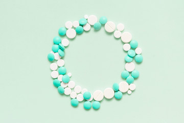 Turquoise, cyan, neo mint colorful chocolate candies isolated on neo mint background. Heap of candies multi colored against a neo mint texture. Top view or flat lay. Color of the year 2020. Main trend