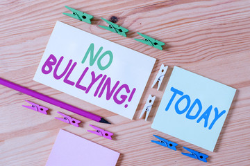 Handwriting text No Bullying. Conceptual photo stop aggressive behavior among children power imbalance Colored clothespin papers empty reminder wooden floor background office