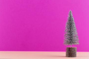 Christmas tree on pastel colored background. Christmas or New Year minimal concept.