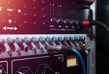 Music tuner. Record sound, music. Making music, recording. Creating sound foundations. Digital sound converter on a red background in the recording room.