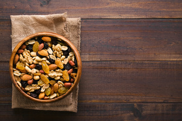 Healthy trail mix snack made of nuts (walnut, almond, peanut) and dried fruits (raisin, sultana) in...