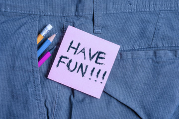 Conceptual hand writing showing Have Fun. Concept meaning wish somebody good and enjoyable time when they do something Writing equipment and pink note paper inside pocket of trousers