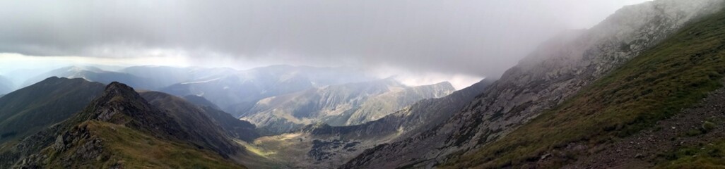 Landscape in the mountains  with stormy clouds above.  Fagaras - Lespezi and Coltu Caltunului Peaks