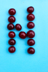 Letter N fresh cherry alphabet blue color flat lay