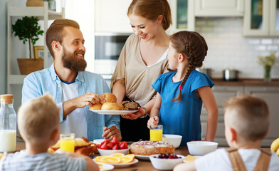 family mother father and children have Breakfast in kitchen in morning.