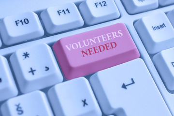 Text sign showing Volunteers Needed. Business photo text need work or help for organization without being paid White pc keyboard with empty note paper above white background key copy space