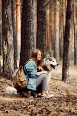 Young Girl with her Dog, Alaskan Malamute, Outdoor at Autumn. Domestic pet