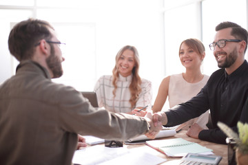 smiling businessman at a working meeting in the office