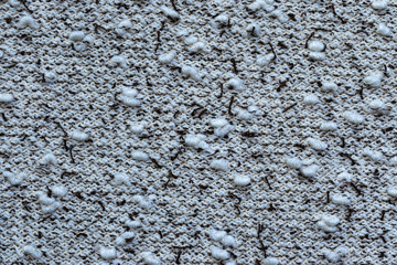 Background in the form of a knitwear with soft white boucle and dark brown veins on a light background