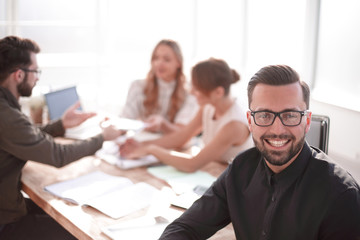 smiling businessman in the background of the office.
