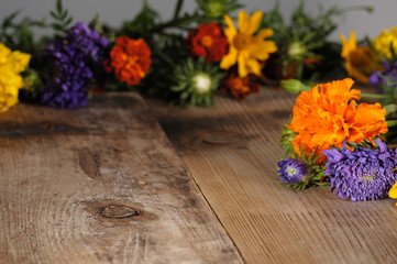 Bouquet with multicolor flowers on a wooden table