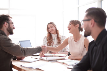 businessman looking at the handshake of business partners