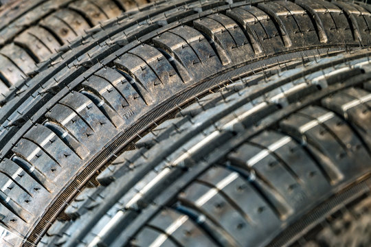 Row of car dirty tires at warehouse in tire store
