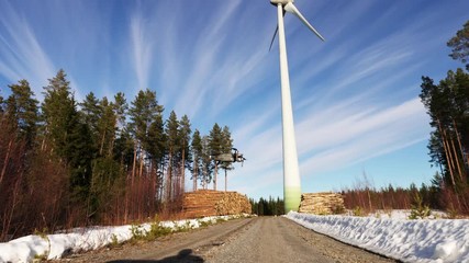 A drone returns back after conducted regular technical control of windmill, flew around, returns with close up video of hardware for further evaluation by technicians