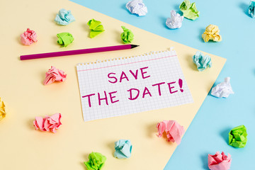Text sign showing Save The Date. Business photo text reserve the mentioned future wedding date on their calendar Colored crumpled papers empty reminder blue yellow background clothespin