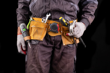 Production worker with tool belt. Worker's hammer.