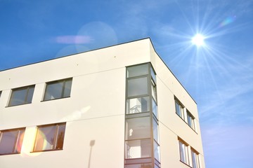 Modern office building detail, glass surface with sunlight