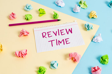Text sign showing Review Time. Business photo text to think or talk about something again Set schedule to review Colored crumpled papers empty reminder blue yellow background clothespin