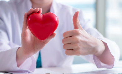 Doctor checking up heart in medical concept