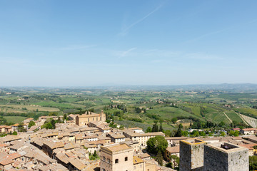 Fototapeta na wymiar Looking out over the Tuscan countryside from a tower inside San Gimignano, a small walled medieval hill town in the province of Siena, Tuscany, north-central Italy