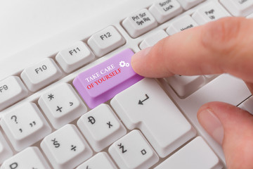 Conceptual hand writing showing Take Care Of Yourself. Concept meaning a polite way of ending a gettogether or conversation White pc keyboard with note paper above the white background