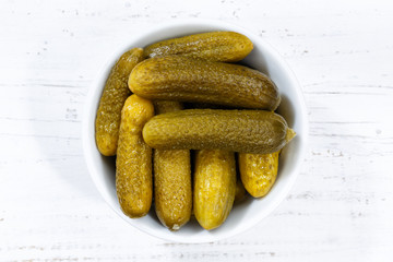 Small gherkins cucumber vegetable vegetables from above bowl wooden board
