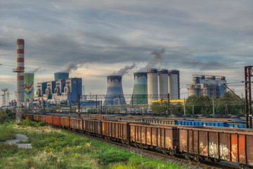Fototapeta premium view of the coal power plant and railway siding, transport of hard coal to the power plant, industrial landscape, environmental protection against air pollution