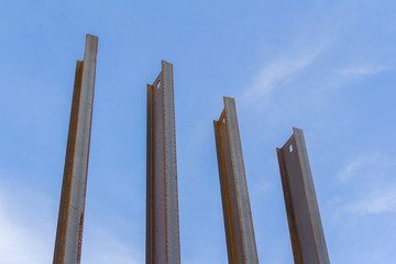 Steel channel on a background of blue sky. The use of steel channel to strengthen the foundation of the house in a construction site.