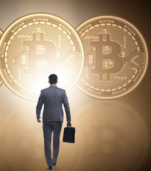 Businessman walking towards bitcoins in cryptocurrency blockchai