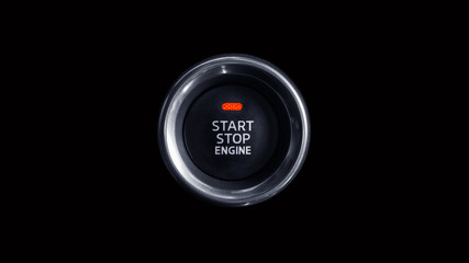 Start stop engine button of modern luxury car. Isolated on black.