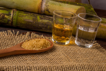 Cacha&ccedil;a is the name of a typical alcoholic drink produced in Brazil maked with sugarcane. Traditional drink from Brazil on wooden table