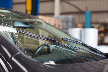 Detailed view of car windshield wipers while they are being used