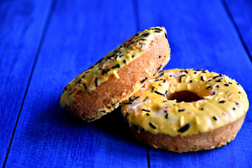 Appetizing donuts on a blue background in the kitchen.