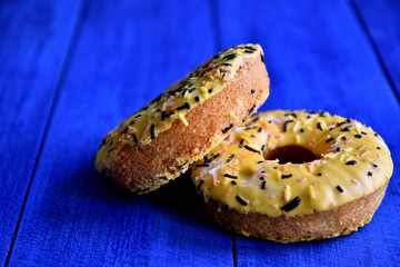 Appetizing donuts on a blue background in the kitchen.