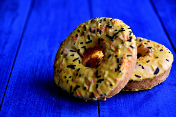 Appetizing donuts on a blue background in the kitchen.