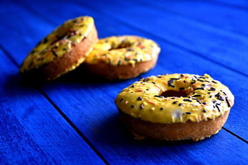 Appetizing donuts on a blue background in the kitchen.