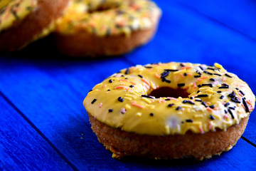 Appetizing donuts on a blue background in the kitchen.