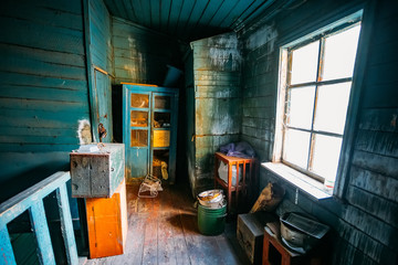 Dark and shabby messy room in poor apartment of old emergency abandoned wooden house, poverty...