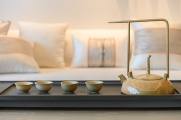 set of teapot and cups inside a living room