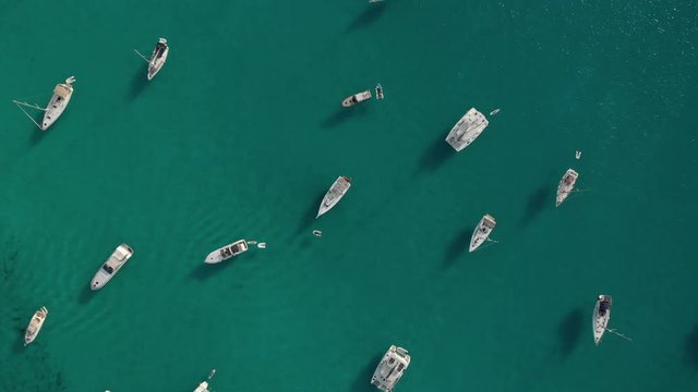 Aerial View of many yachts in a bay on Formentera island. Cala Saona bay drone footage. Yachting in the Balearic islands