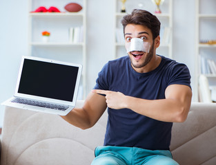 Young man recovering healing at home after plastic surgery nose