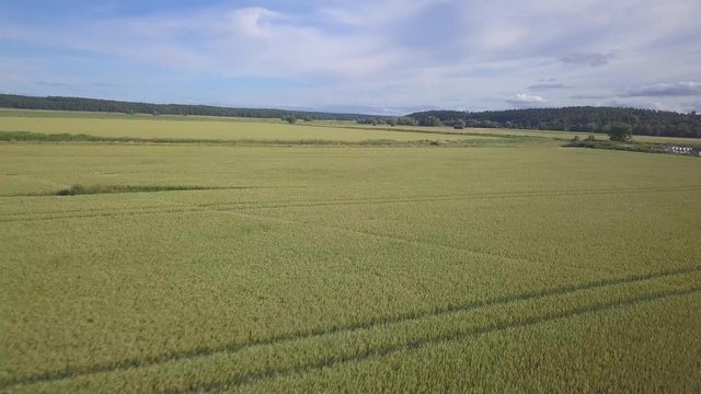 Aerial footage of field and blue sky in Arlanda, Sweden