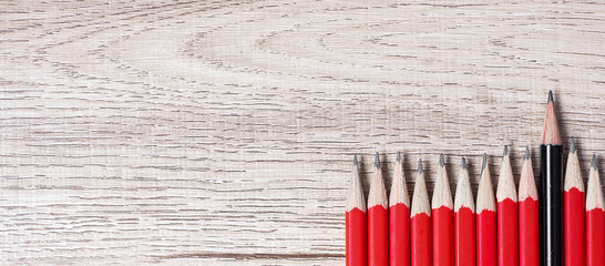 Black pencil different from crowd of red pencils. Unique Leader, strategy, independence, think different, business and success concept